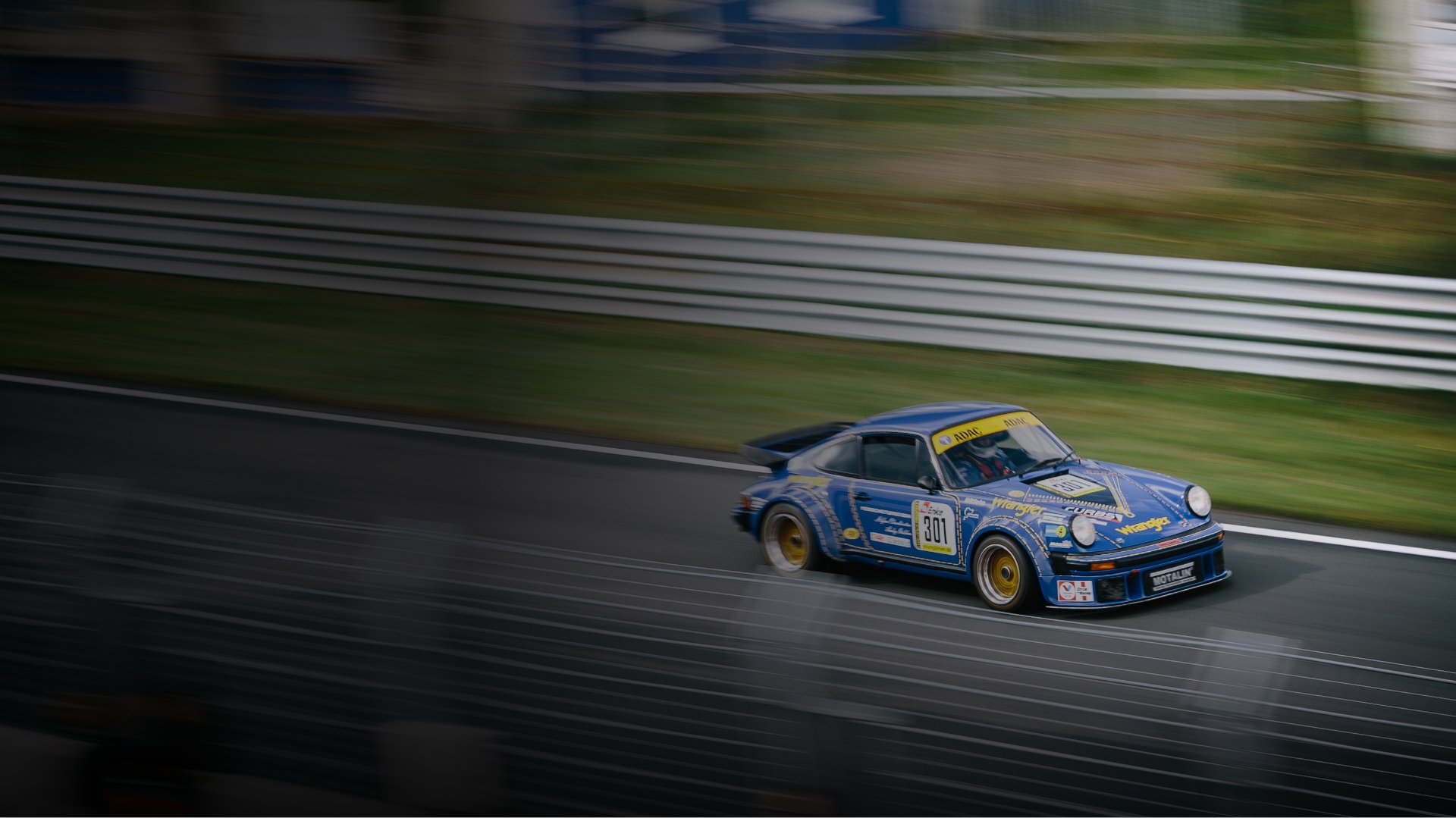 Image of a Porsche making its way around a race track.