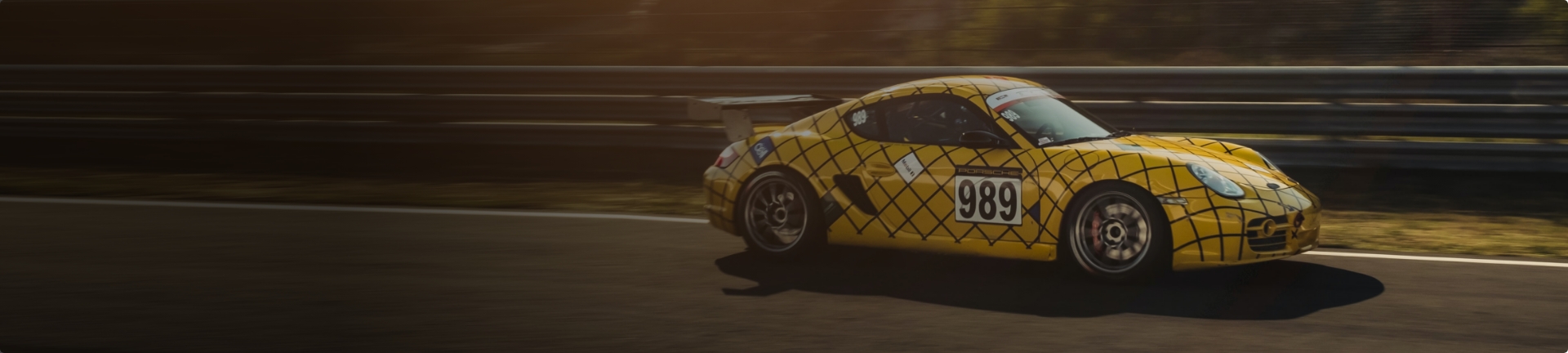 Image of a Porsche making its way around a race track.